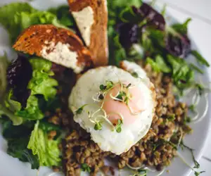 Fried egg over a green salad