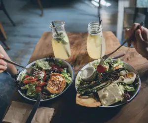 Two people enjoying salads